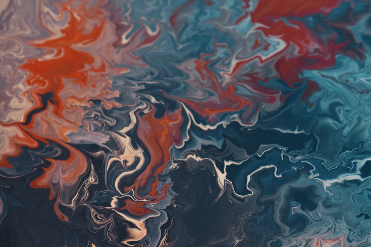 gallery-5 Dynamic abstract fluid art showcasing a vibrant mix of blues and reds creating energetic patterns.